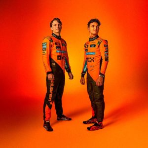 Ultimate Go-Kart Racing Suit - Premium Orange & Black Motorsport Suit with Custom Embroidered Logos, featuring sponsor patches from Dell Technologies, Cisco, and Android, made with durable Cardura 600D outer material, cotton terry lining, 3D digital sublimation printing, stretch panels, and breathable vents, ideal for racers seeking performance and style.